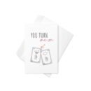 A cute and punny Valentine's Day card featuring two happy light switches with blushing faces and the phrase "You Turn Me On" in a playful font.