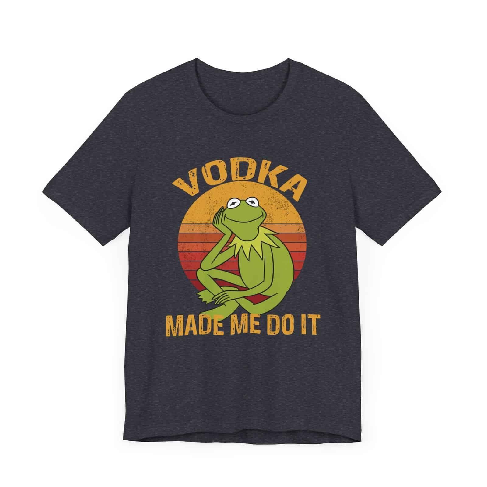 A dark-colored t-shirt featuring a retro-style design with a relaxed green frog and the phrase 'Vodka Made Me Do It'."