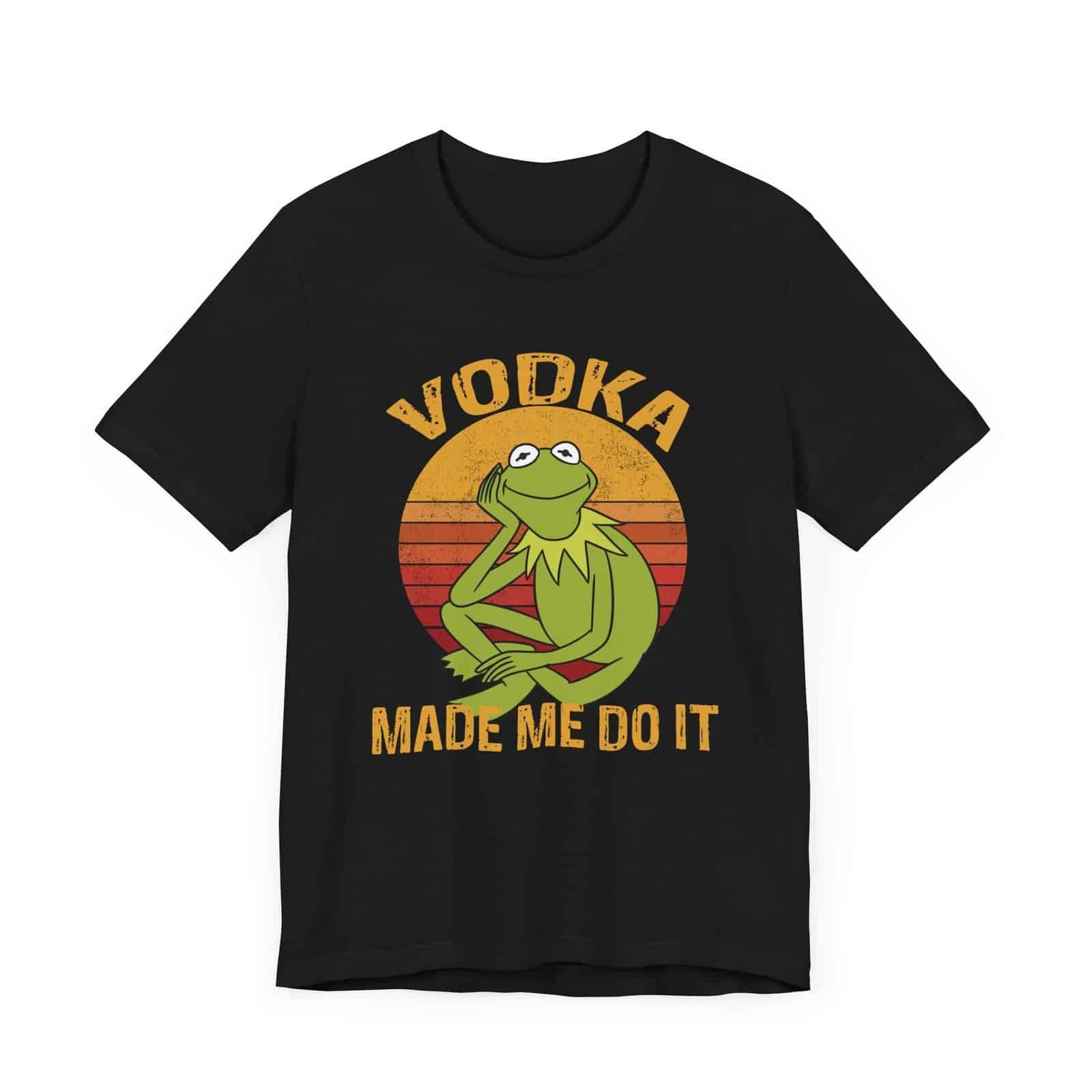 A dark-colored t-shirt featuring a retro-style design with a relaxed green frog and the phrase 'Vodka Made Me Do It'."