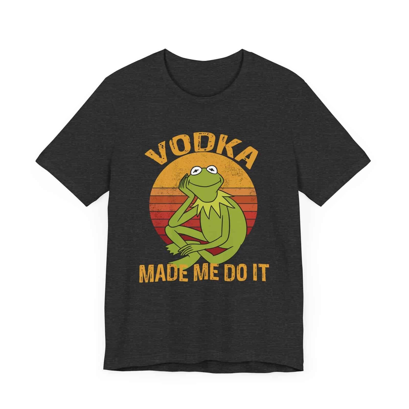 A dark-colored t-shirt featuring a retro-style design with a relaxed green frog and the phrase 'Vodka Made Me Do It'."