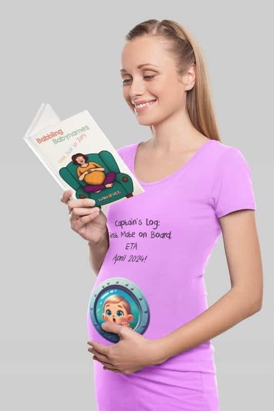 A pregnant woman wearing a light purple maternity t-shirt with a fun nautical-themed pregnancy announcement that reads, "Captain’s Log: First Mate on Board, ETA April 2024!" The shirt features a porthole design on her belly showing a cartoon baby peeking out. She is smiling while reading a humorous baby name book.